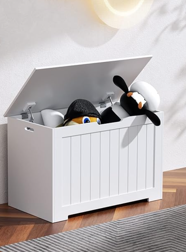 White kids toy chest, lid open with stuffed animals coming out