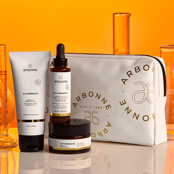 DermResults Glow Skincare Set Arbonne on display with orange background