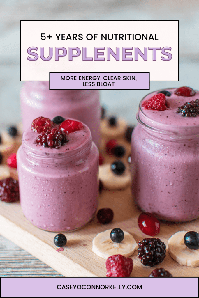Pinterest Blog cover "5+ Years of Nutritional Supplements: more energy, clear skin, less bloat" "caseyoconnorkelly.com"

Image of three small jars with purple smoothies with berries on top, with berries & sliced bananas around the jars, all on a wood cutting board.

Smoothie in the back is blurred.